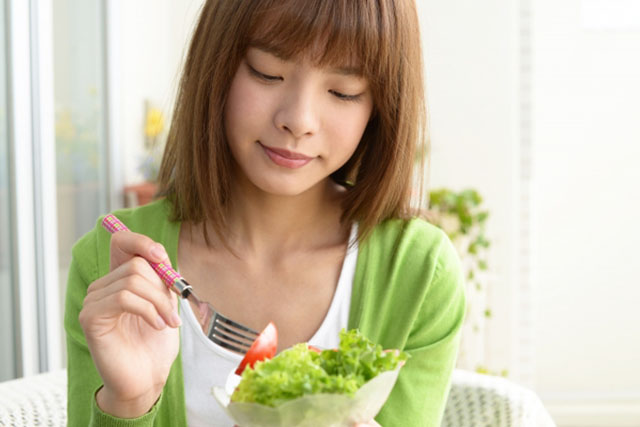 サラダを食べる女性