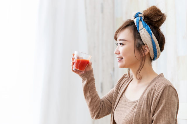 野菜ジュースを飲む女性